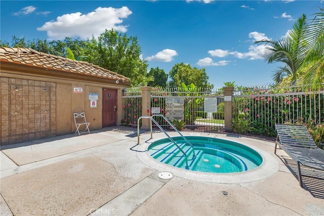 view of pool featuring a patio area, a hot tub, and fence