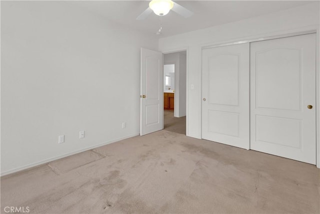 unfurnished bedroom with carpet flooring, a closet, and ceiling fan