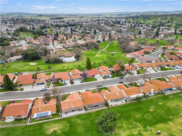 birds eye view of property featuring view of golf course and a residential view