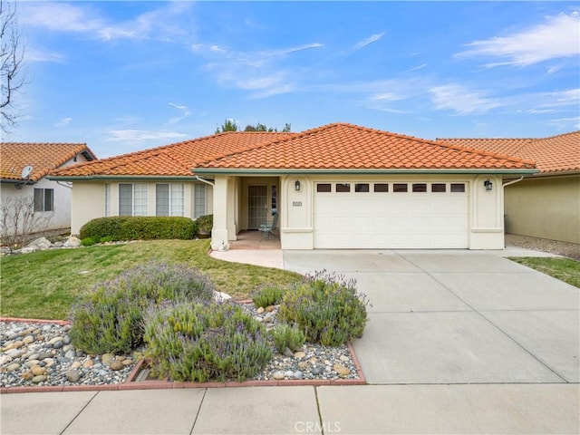 view of front of home featuring stucco siding, a tiled roof, and concrete driveway