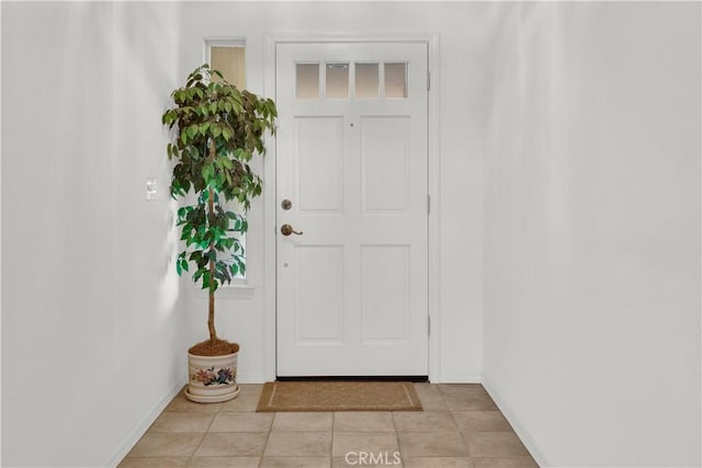 interior space featuring light tile patterned floors and baseboards