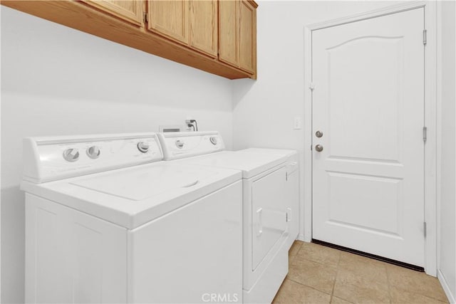 washroom with cabinet space and washing machine and dryer