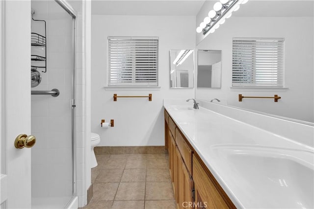 full bath with tile patterned floors, a sink, double vanity, and a shower stall