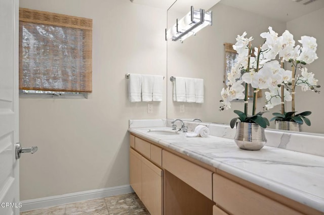 bathroom featuring visible vents, vanity, and baseboards