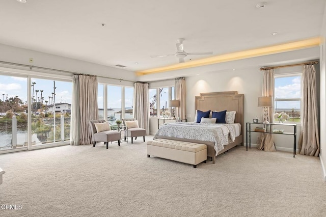 bedroom with multiple windows, carpet, and ceiling fan