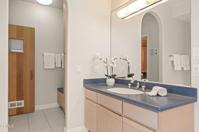 bathroom with vanity, tile patterned floors, baseboards, and visible vents