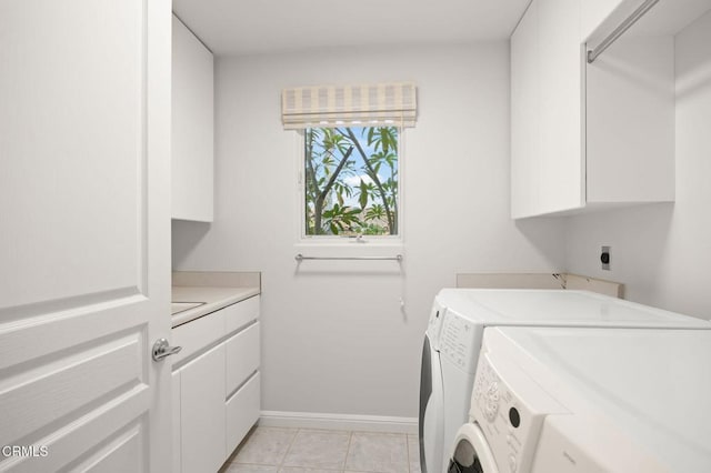 washroom featuring light tile patterned floors, cabinet space, independent washer and dryer, and baseboards