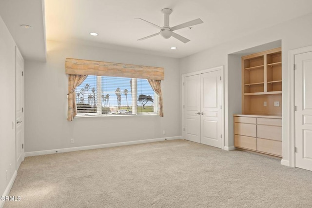 unfurnished bedroom featuring light carpet, recessed lighting, a closet, and baseboards