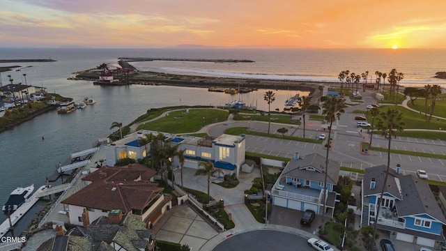 aerial view at dusk with a water view