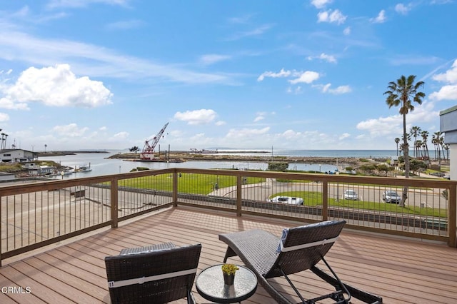 wooden terrace featuring a water view