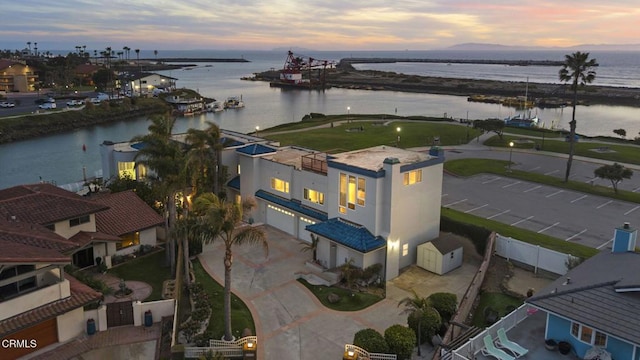 aerial view at dusk with a water view