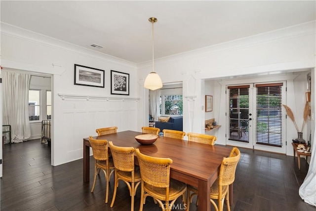 dining space featuring visible vents, a healthy amount of sunlight, dark wood finished floors, and ornamental molding