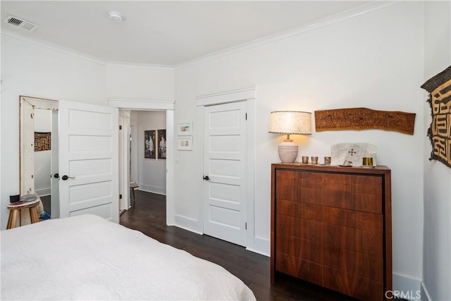 bedroom featuring crown molding, baseboards, visible vents, and dark wood-type flooring