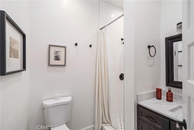 full bath featuring vanity, toilet, and a stall shower