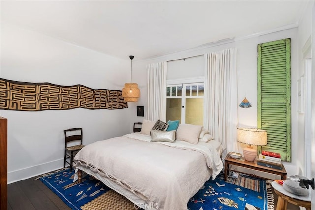 bedroom featuring wood finished floors and baseboards