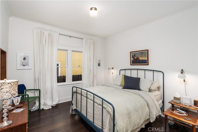 bedroom featuring dark wood-type flooring and ornamental molding