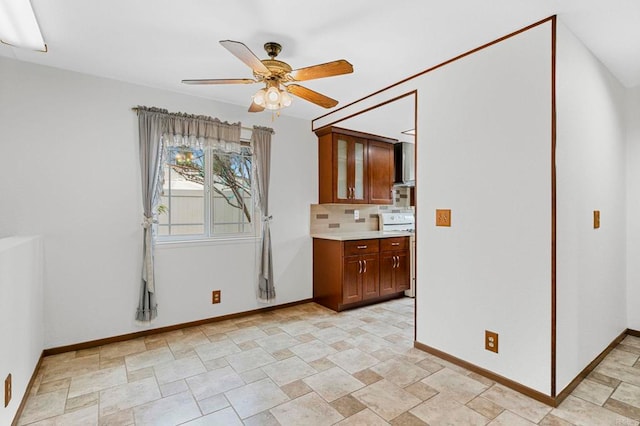 interior space with baseboards and ceiling fan