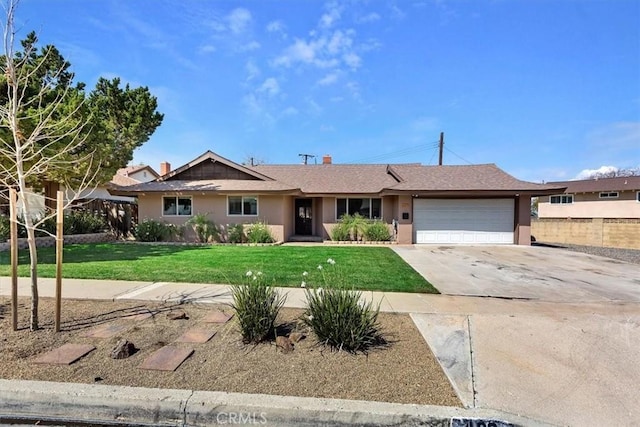 ranch-style house with a garage, driveway, a front lawn, and stucco siding