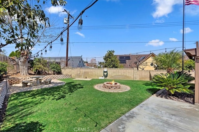 view of yard with a fenced backyard and an outdoor fire pit