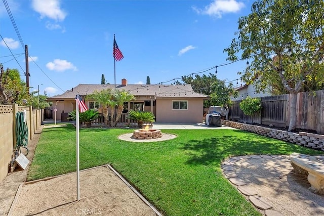 back of house with an outdoor fire pit, a fenced backyard, stucco siding, a patio area, and a lawn