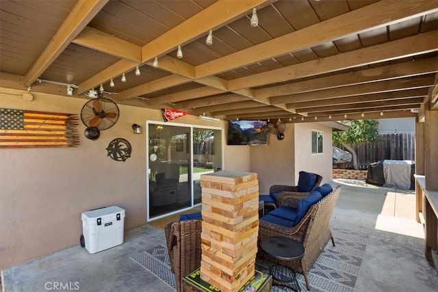 view of patio featuring grilling area, outdoor lounge area, and fence