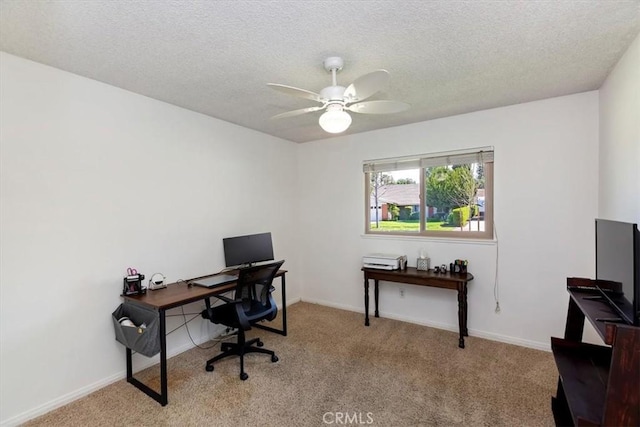 carpeted office featuring ceiling fan, baseboards, and a textured ceiling