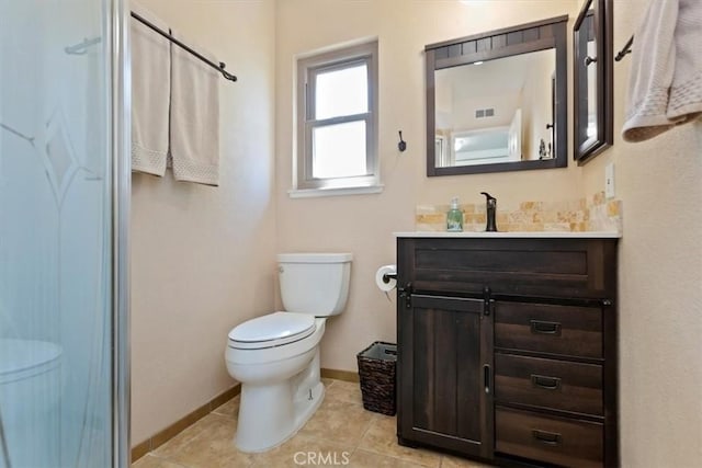 bathroom featuring tile patterned floors, baseboards, toilet, and vanity