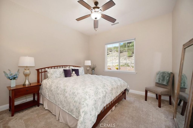 bedroom featuring a ceiling fan, baseboards, visible vents, and light carpet