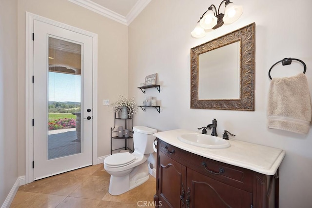 bathroom with vanity, baseboards, crown molding, toilet, and tile patterned floors