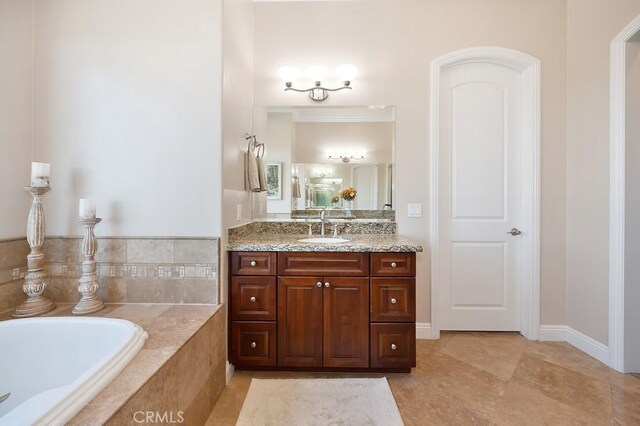 full bathroom with vanity and a bath