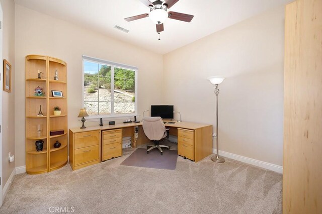 office area featuring light carpet, visible vents, and baseboards