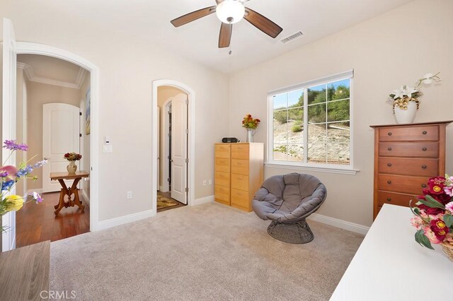 bedroom featuring visible vents, ceiling fan, baseboards, carpet floors, and arched walkways