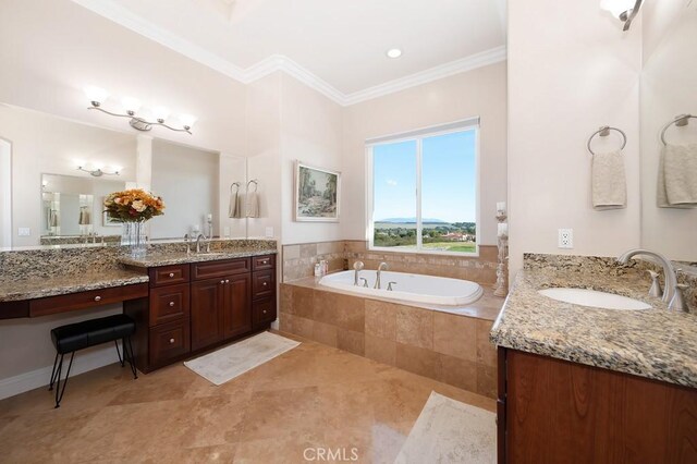 bathroom featuring two vanities, crown molding, a bath, and a sink