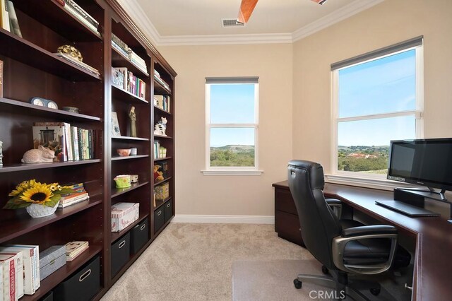 office area with ornamental molding, visible vents, a wealth of natural light, and light carpet