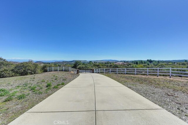 exterior space with a mountain view, a rural view, and fence