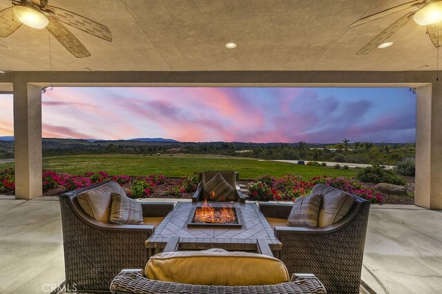 view of patio / terrace featuring an outdoor living space with a fire pit and ceiling fan