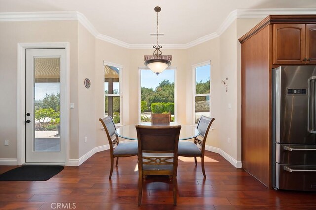 dining space with visible vents, ornamental molding, baseboards, and dark wood-style flooring