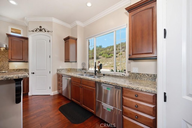 kitchen with a sink, dark wood-type flooring, stainless steel dishwasher, and crown molding