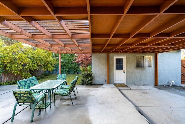 view of patio with outdoor dining area, fence, and a pergola