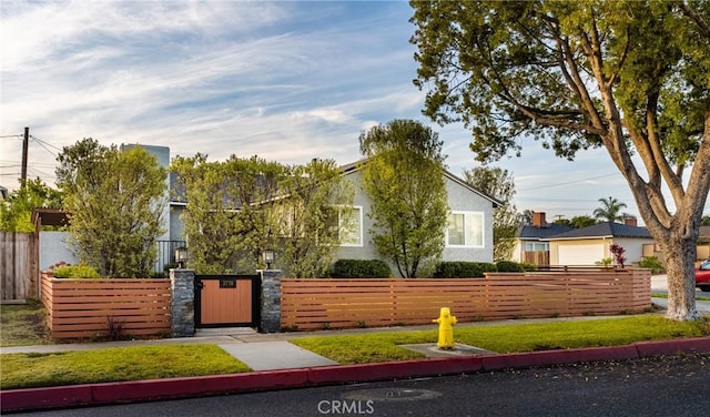 view of property's community with a fenced front yard and a lawn