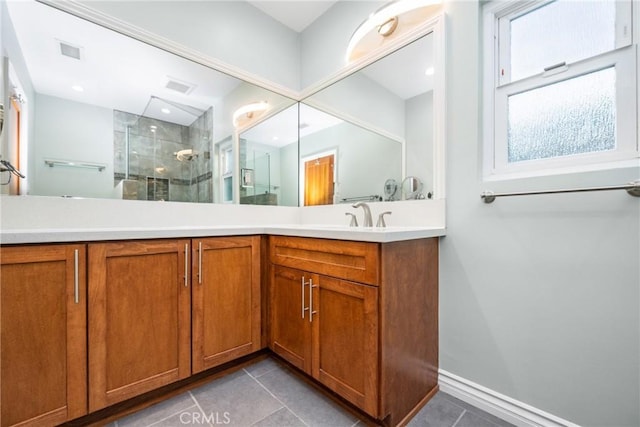 bathroom with visible vents, a stall shower, vanity, and tile patterned flooring