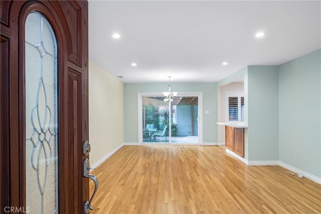 entrance foyer featuring light wood-type flooring, visible vents, recessed lighting, an inviting chandelier, and baseboards