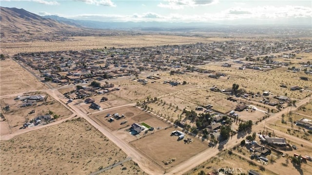 drone / aerial view featuring a mountain view, a desert view, and a rural view