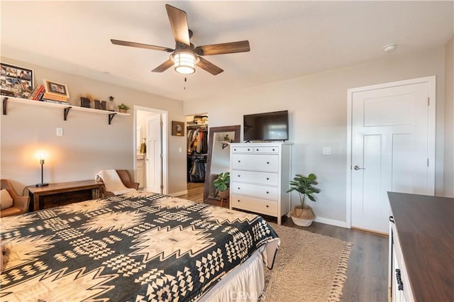 bedroom featuring a closet, baseboards, dark wood-style floors, and a ceiling fan