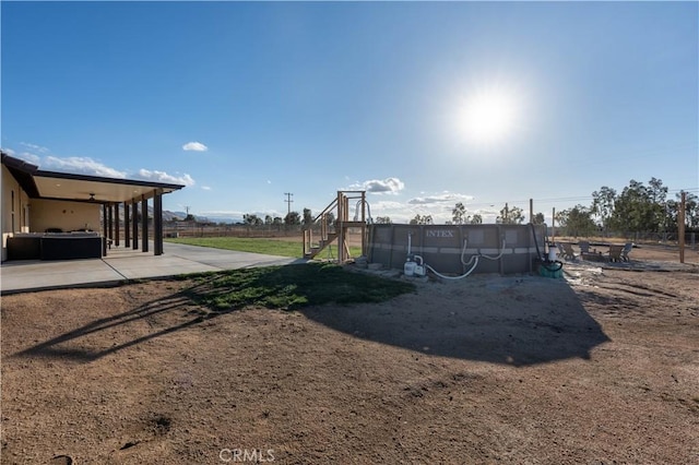 view of yard featuring a pool and a patio area