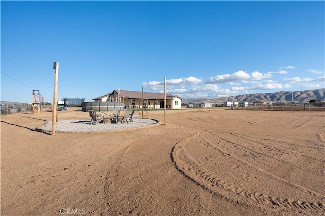 exterior space with a mountain view and fence