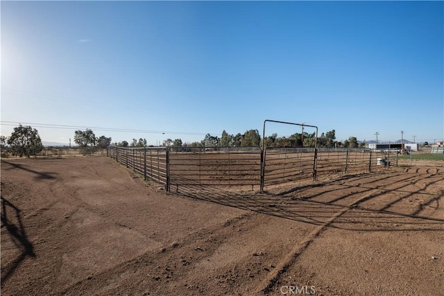 view of yard with a rural view and an enclosed area