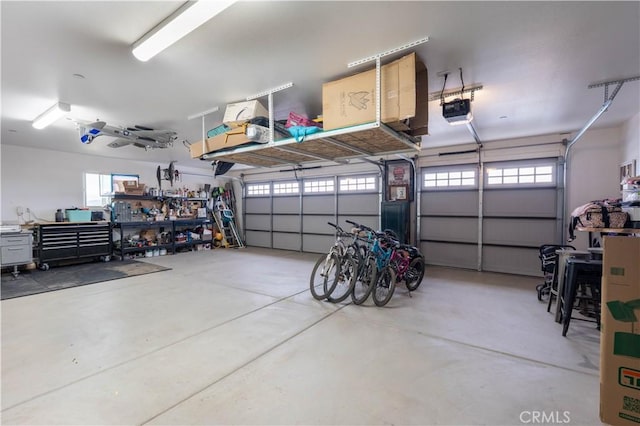 garage with a workshop area and a garage door opener