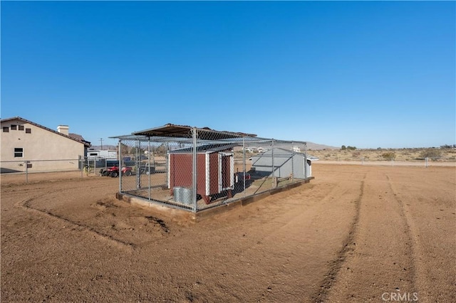 view of outbuilding featuring an outdoor structure and fence