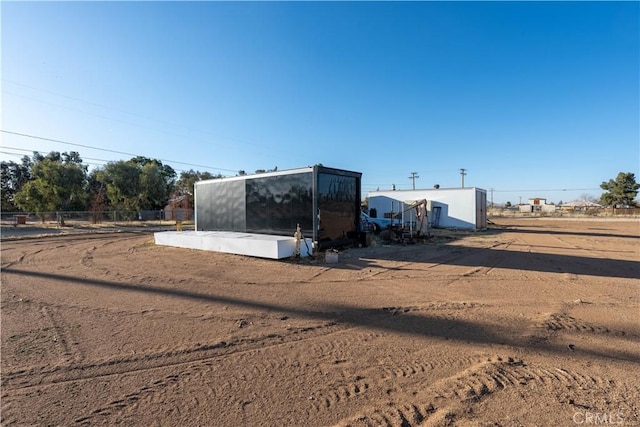 view of outdoor structure featuring an outbuilding and fence